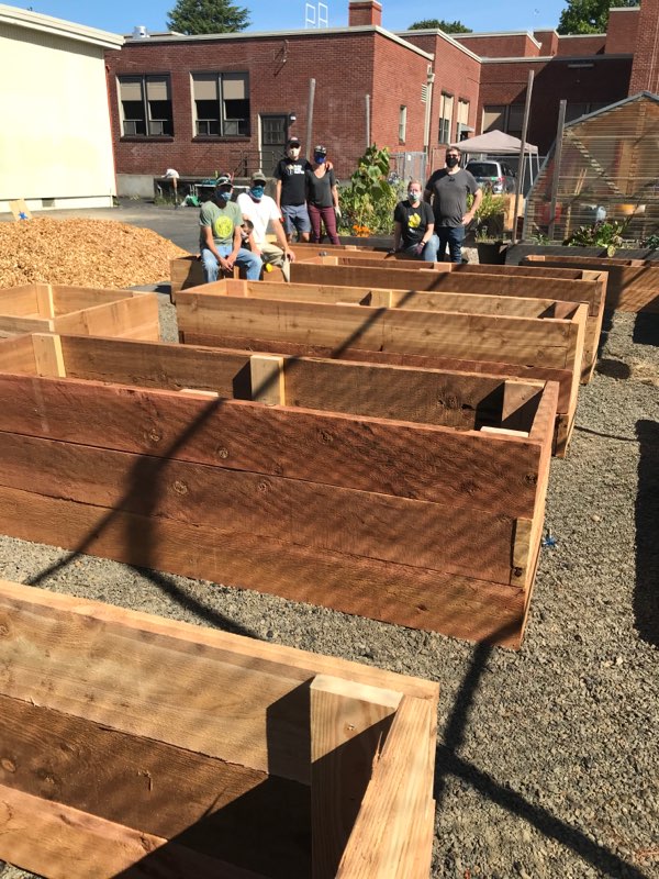 Volunteers building garden beds